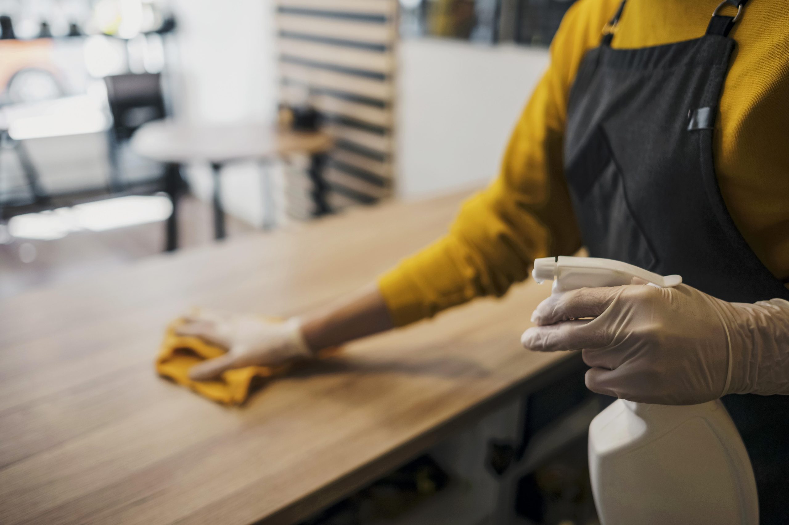 Professional cleaning staff sanitizing a restaurant table in London