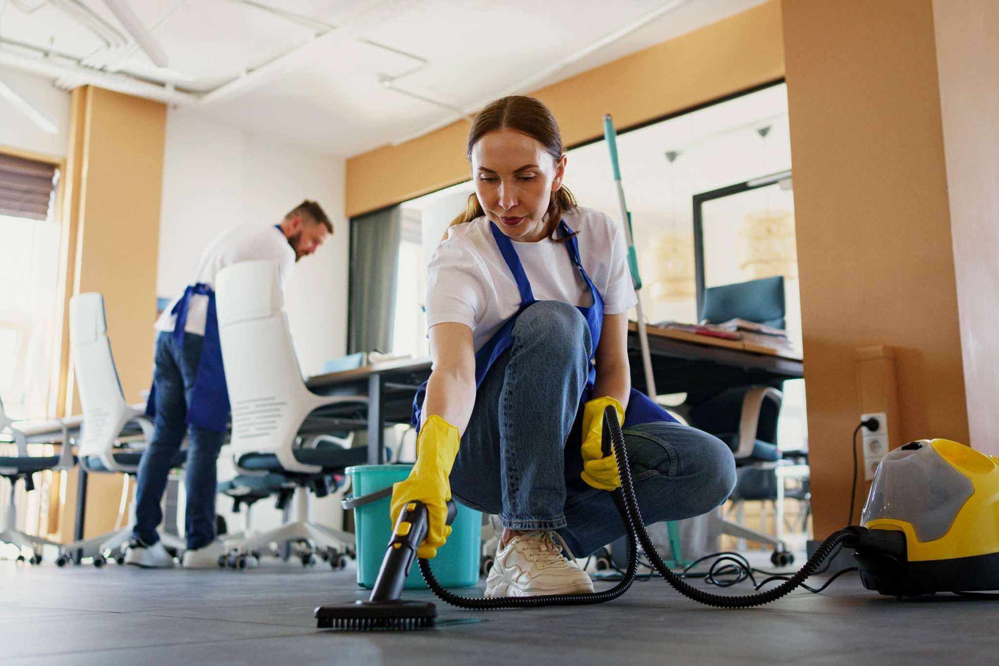 Office cleaner using professional vacuum equipment for deep floor disinfection in London